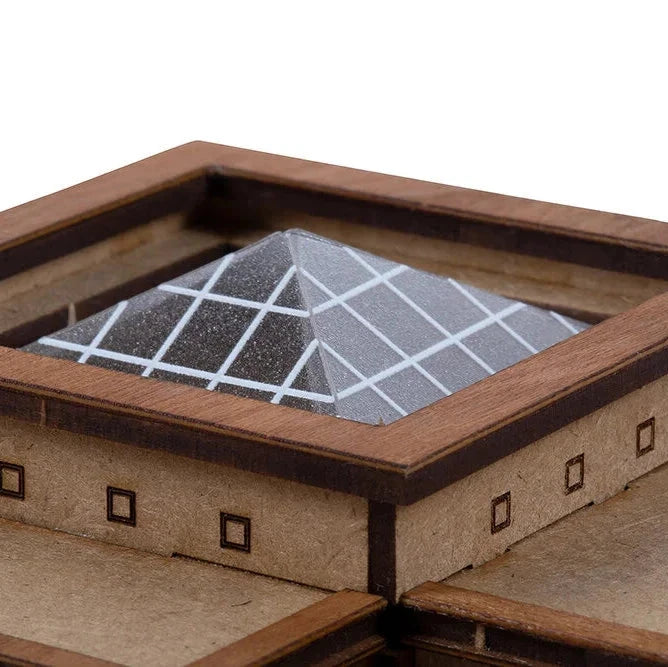 Wooden model of a pyramid with a grid on top, set against a white background
