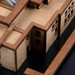Close-up of a wooden architectural model with detailed edges.
