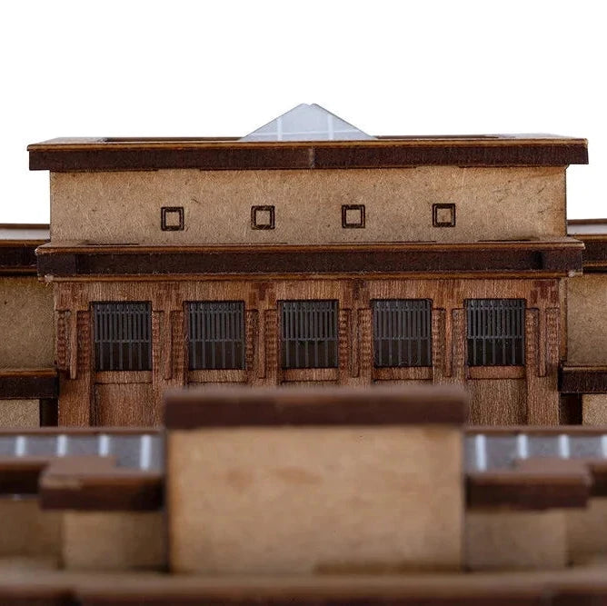 Model of a building with a pyramid-shaped roof on a white background