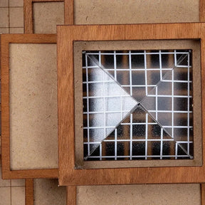 Wooden frames with a metal grid design on a textured beige background
