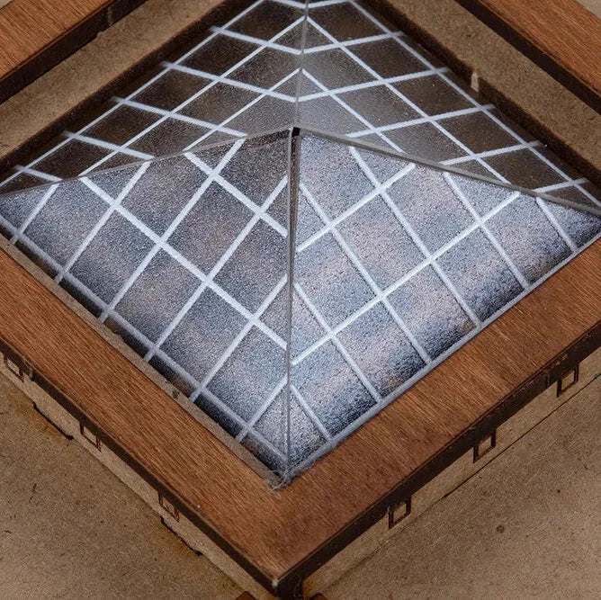 Wooden box with a glass lid featuring a geometric pattern on a wooden surface.