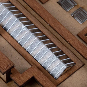Set of metal files in a wooden holder on a wooden surface
