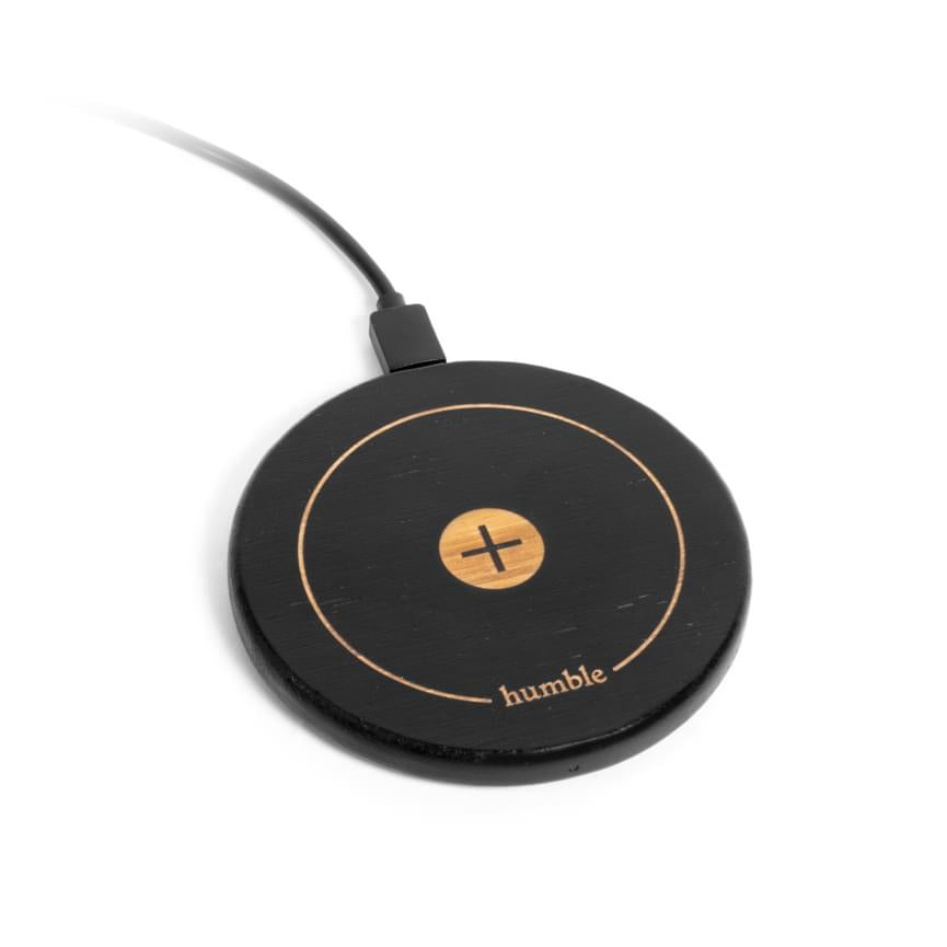 A black wireless charger with a gold circle design in the center and the brand name 'Humble' written on it.