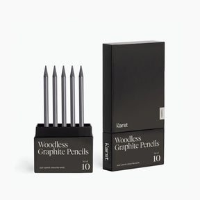 Karst woodless graphite pencils set of 10, showing five sharpened graphite pencils standing in an open black box beside the closed minimalist black packaging on a white background.