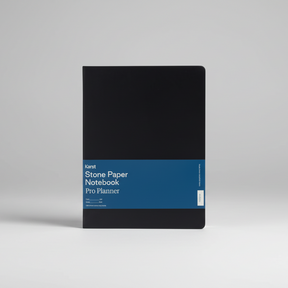 Black notebook with blue band featuring 'Stone Paper Notebook Pro Planner' text on a white background