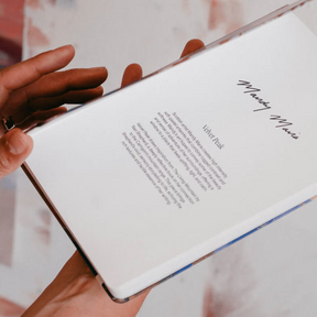 Hand holding a smartphone with a blurred background