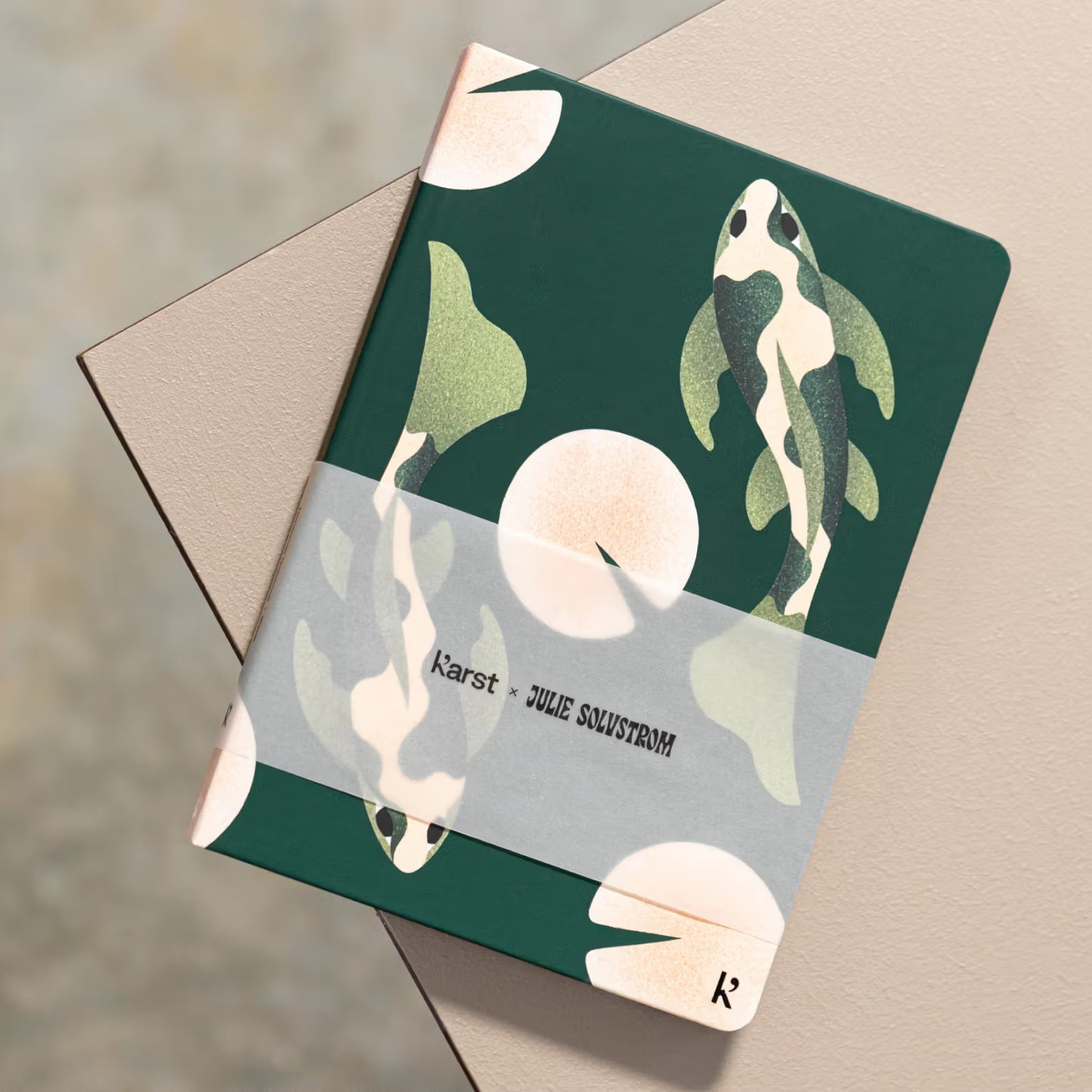 Notebook with decorative cover featuring plants on a textured surface