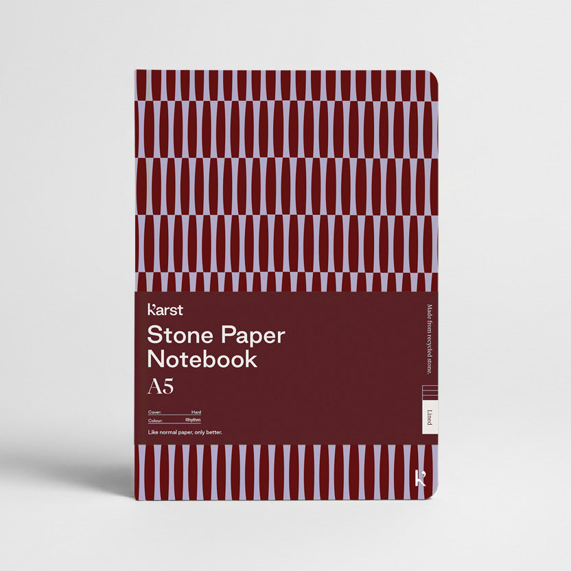 Stone Paper Notebook with red and white striped design on a light gray background
