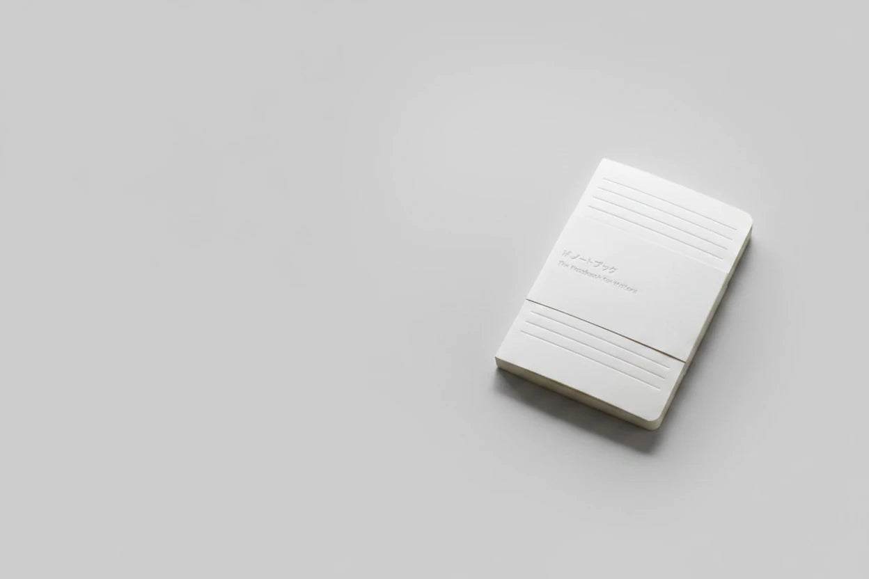 White rectangular device with text on a textured beige surface