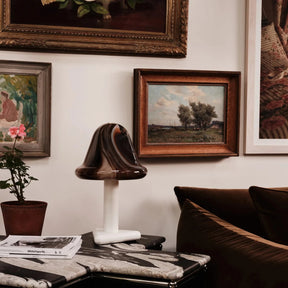Living room with a sofa, table, and framed artwork on the wall.
