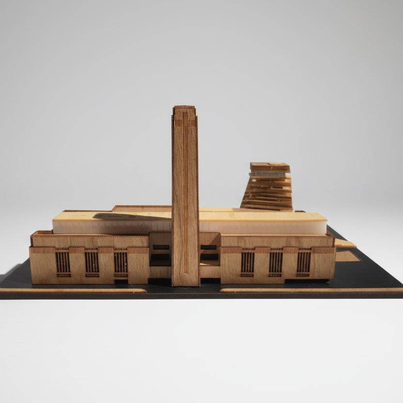 Model of a factory building on a black base with a white background