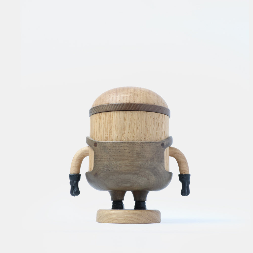 Wooden Minion character figurine with carved goggles, smiling face, gray overalls, black gloves, and boots, standing on a round wooden base labeled “Bob”.