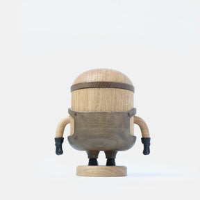 Wooden Minion character figurine with carved goggles, smiling face, gray overalls, black gloves, and boots, standing on a round wooden base labeled “Bob”.