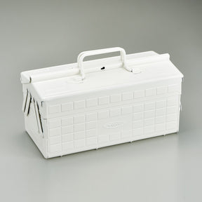 White Toyo steel cantilever toolbox, closed, shown at a three-quarter angle with embossed grid panels, folded side arms, and a fixed top handle against a neutral studio background.
