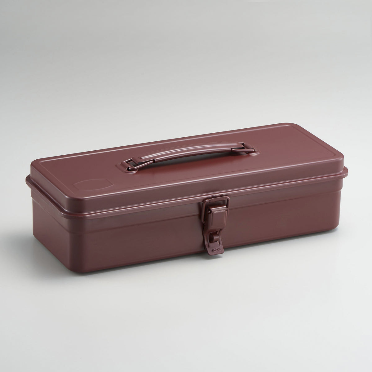 Antique brown Toyo Steel metal toolbox with a rectangular silhouette, glossy powder-coated finish, integrated top handle, and single front latch, shown closed against a neutral light gray background.