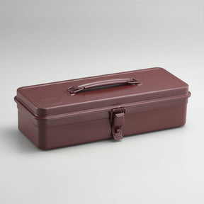 Antique brown Toyo Steel metal toolbox with a rectangular silhouette, glossy powder-coated finish, integrated top handle, and single front latch, shown closed against a neutral light gray background.