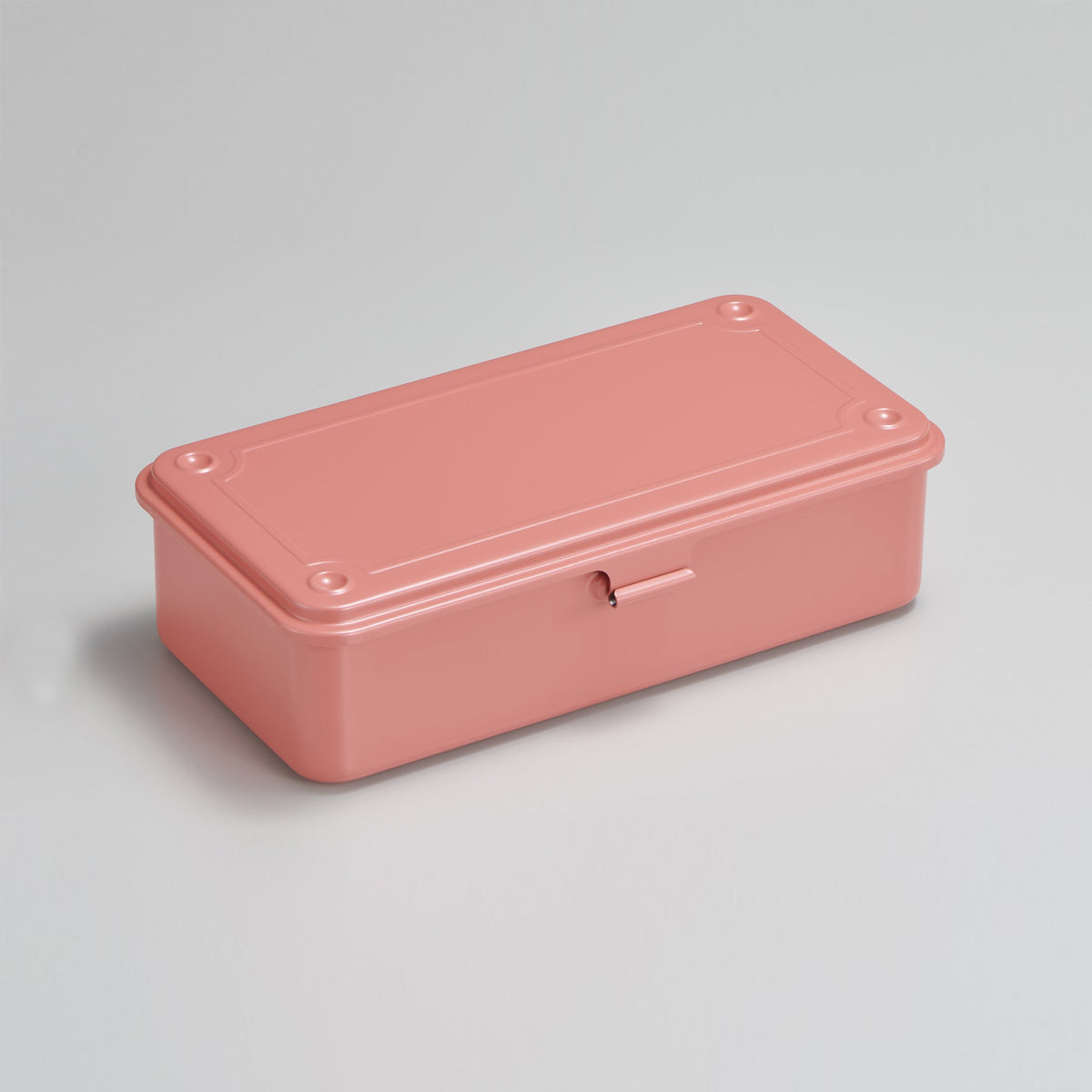 Live coral Toyo Steel T-190 compact metal storage box with rounded corners and front pull tab, shown closed on a light neutral background.