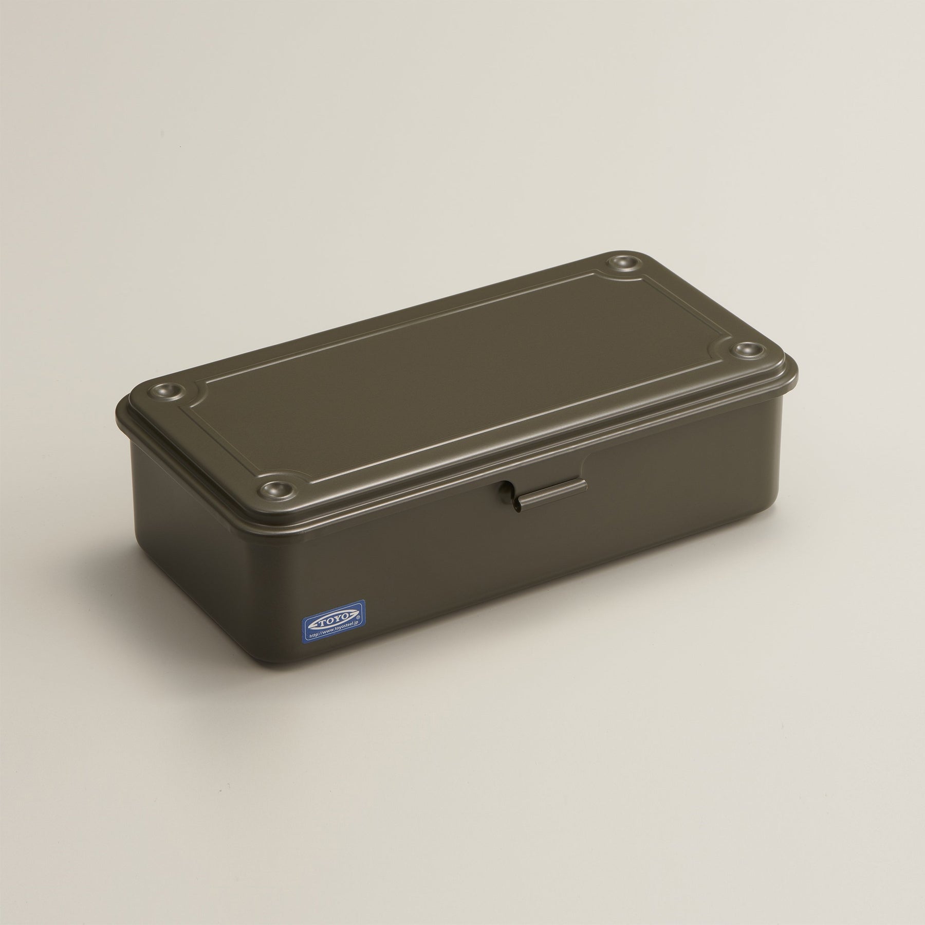 military green Toyo Steel T-190 compact metal storage box with rounded corners and a front pull tab, shown closed on a neutral light background.