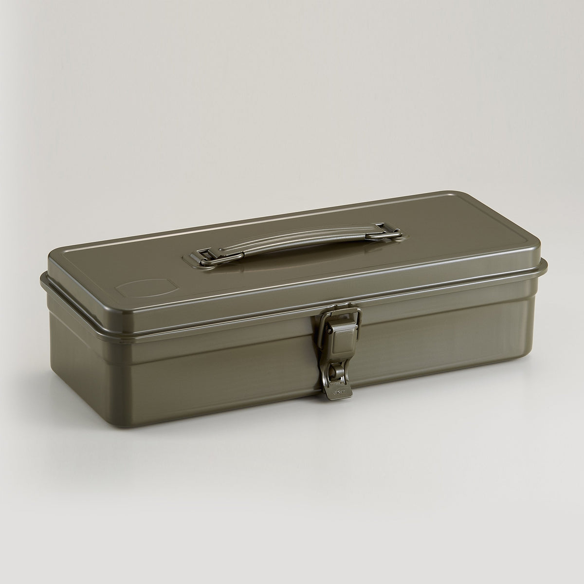 military green Toyo Steel metal toolbox with a low rectangular profile, smooth enamel finish, integrated top handle, and single front latch, photographed closed against a neutral light background.