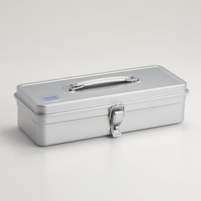 Silver Toyo Steel T-320 metal toolbox with a smooth rectangular form, satin powder-coated finish, integrated folding top handle, and single front latch, photographed closed on a clean light gray background.