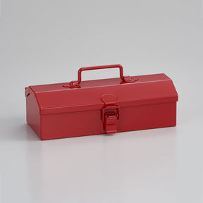 Angled front view of a red Toyo Steel Y-17 metal toolbox with a top carry handle and central latch, photographed on a neutral light gray studio background.