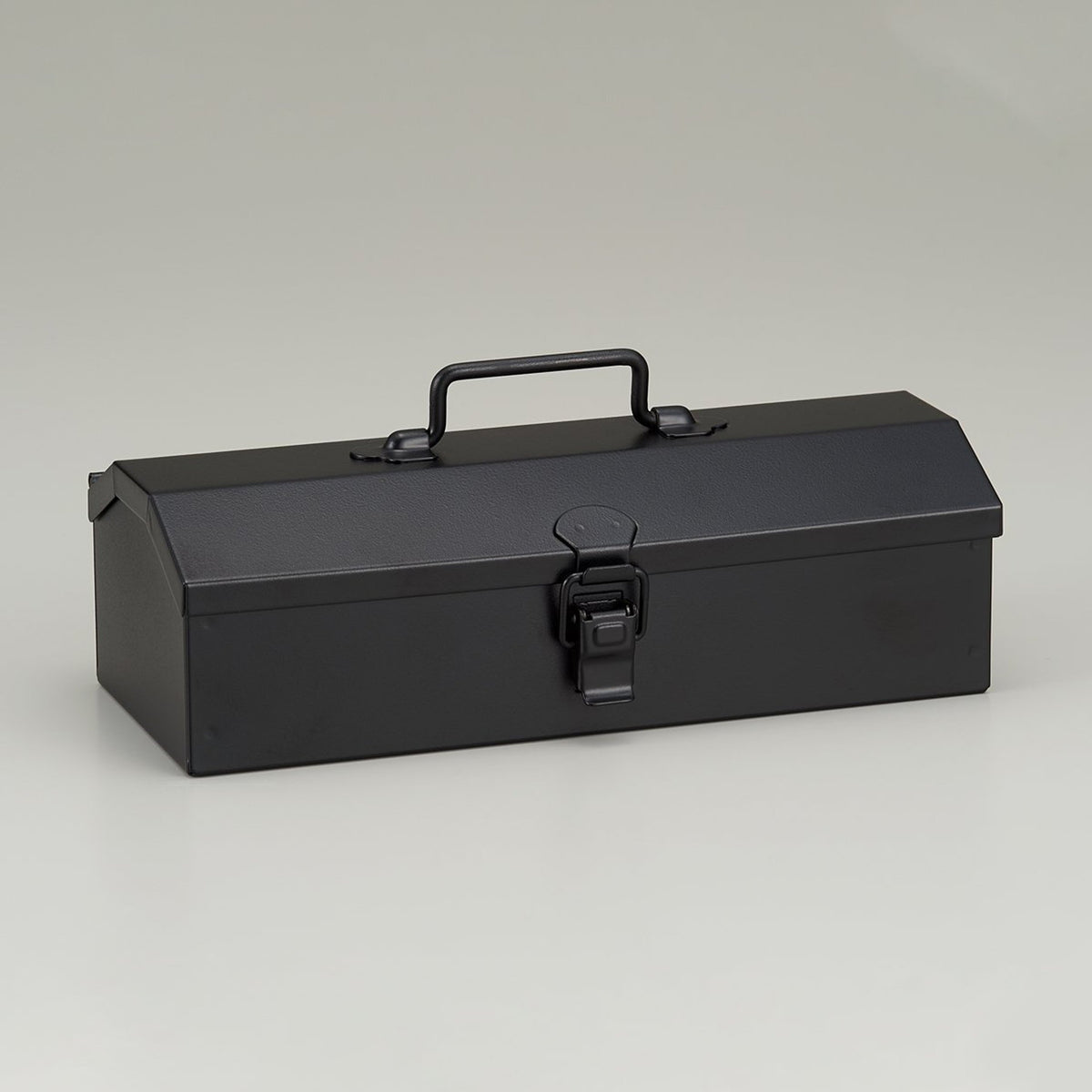 Front three-quarter view of a black Toyo Steel Y-20 metal toolbox with a top carry handle and front latch, shown closed against a light gray background.