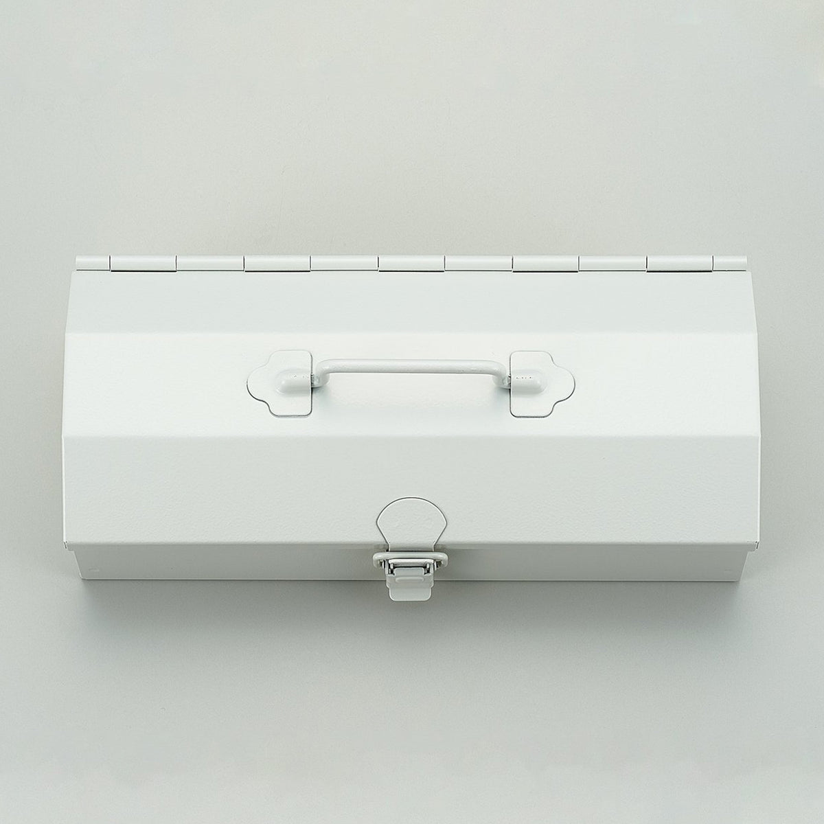Top-down view of a white Toyo Steel Y-20 metal toolbox, featuring a central top handle and front latch, photographed closed on a light gray background.