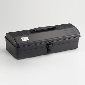 Black Toyo Y-350 steel toolbox with matte finish, elongated rectangular shape, integrated top handle, and single front latch, shown closed on a light neutral studio background.