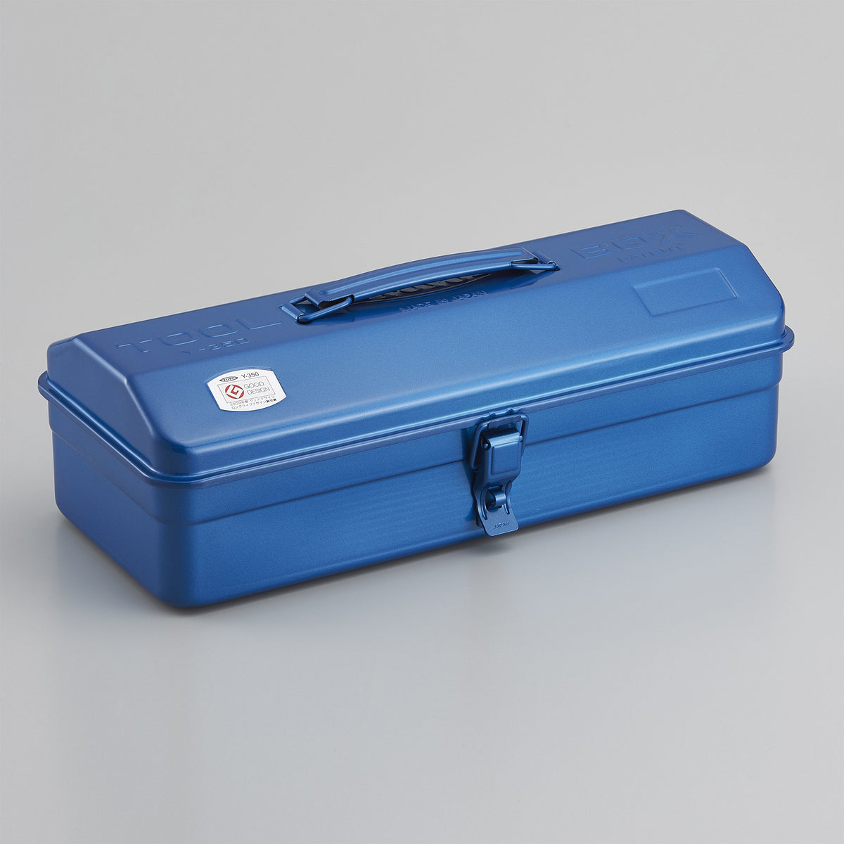 Blue Toyo Y-350 steel toolbox with a rounded lid, top carry handle, and single front latch, shown closed on a light gray background.